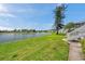 Scenic lakeside view with green lawn and walkway to townhomes with pristine skies at 4734 Cobia Se Dr # A, St Petersburg, FL 33705