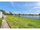 Well maintained lawn near the lake with a paved walkway in a picturesque waterfront community at 4734 Cobia Se Dr # A, St Petersburg, FL 33705