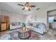 Inviting living area with neutral tones, ceiling fan, tile flooring and comfortable seating arrangements at 4734 Cobia Se Dr # A, St Petersburg, FL 33705