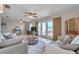 Spacious living area with tile floors, fan, comfortable seating, and access to outdoor waterfront patio at 4734 Cobia Se Dr # A, St Petersburg, FL 33705