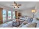 Bright living room with ceiling fan, tile floors, access to a patio overlooking the serene waterfront at 4734 Cobia Se Dr # A, St Petersburg, FL 33705