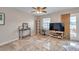 Bright living space with tile floors, ceiling fan, workstation, and access to a patio overlooking the water at 4734 Cobia Se Dr # A, St Petersburg, FL 33705
