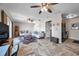 Open living space with tile floors, ceiling fan, and workstation, seamlessly connecting to the kitchen at 4734 Cobia Se Dr # A, St Petersburg, FL 33705