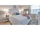 Serene main bedroom features a decorative mirror, a queen bed, and ambient lighting, creating a relaxing space at 4734 Cobia Se Dr # A, St Petersburg, FL 33705