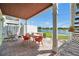 Patio features a dining set for outdoor relaxation, overlooking tranquil water at 4734 Cobia Se Dr # A, St Petersburg, FL 33705