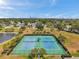 Aerial view of well-kept tennis courts in a community setting, with a city skyline in the distance at 4734 Cobia Se Dr # A, St Petersburg, FL 33705