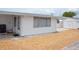 Features a clean exterior with an enclosed shed for storage and a gravel yard, offering a low-maintenance outdoor space at 4922 Genesis Ave, Holiday, FL 34690