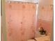 Cozy bathroom featuring a floral shower curtain and complemented by pink tile and matching accessories at 4922 Genesis Ave, Holiday, FL 34690