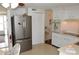 Well-equipped kitchen with stainless steel refrigerator and white cabinets, offering functionality and style at 4922 Genesis Ave, Holiday, FL 34690
