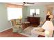 Relaxing living room featuring light green walls, wood-look floors, and comfortable furniture at 4922 Genesis Ave, Holiday, FL 34690