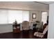 Inviting living room with lots of natural light from several windows; complete with comfortable seating and wood-look floors at 4922 Genesis Ave, Holiday, FL 34690