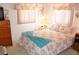 Bright bedroom with lots of natural light, featuring a bed with seashell-themed bedding and a wood dresser at 4922 Genesis Ave, Holiday, FL 34690