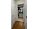 Hallway view into a bathroom with tile flooring, vanity with white cabinets, and good lighting at 4967 Steel Dust Ln, Lutz, FL 33559