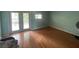 Bedroom with hardwood floors, double doors, and natural light at 4967 Steel Dust Ln, Lutz, FL 33559