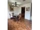 Dining room boasts a glass table, wrought iron chairs, tile flooring, and natural light at 4967 Steel Dust Ln, Lutz, FL 33559