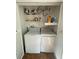 Functional laundry closet with a washer and dryer, plus shelving for storage at 4967 Steel Dust Ln, Lutz, FL 33559