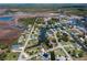 Scenic aerial view of a charming neighborhood along winding canals, showcasing waterfront living and lush greenery at 5144 Cedarbrook Ln, Hernando Beach, FL 34607