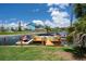Spacious backyard featuring a screened-in patio, waterfront access, lush landscaping, and ample greenery at 5144 Cedarbrook Ln, Hernando Beach, FL 34607