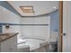 Modern bathroom featuring tile shower, skylight, and vanity at 5144 Cedarbrook Ln, Hernando Beach, FL 34607