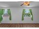 Bedroom with wood-look floors and two windows that offer a view of the lake at 5144 Cedarbrook Ln, Hernando Beach, FL 34607