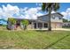Charming two-story home with stone accents, solar panels, a two-car garage, and lush green landscaping at 5144 Cedarbrook Ln, Hernando Beach, FL 34607