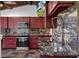 Kitchen features a granite countertop, stainless steel appliances and dark wood cabinetry at 5144 Cedarbrook Ln, Hernando Beach, FL 34607