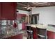 Modern kitchen featuring granite countertops, stainless steel appliances, and a decorative ceiling at 5144 Cedarbrook Ln, Hernando Beach, FL 34607