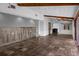 Spacious living room with stone floors, wood beams and staircase access at 5144 Cedarbrook Ln, Hernando Beach, FL 34607