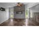 Cozy living room with stone fireplace, tile floors and natural light at 5144 Cedarbrook Ln, Hernando Beach, FL 34607