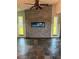 Living room with modern fireplace feature, stylish fan, and slate flooring at 5144 Cedarbrook Ln, Hernando Beach, FL 34607