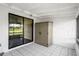 Covered patio with tile flooring, a storage cabinet, and sliding glass door at 5144 Cedarbrook Ln, Hernando Beach, FL 34607