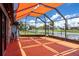 Enclosed patio with orange awning, overlooking a canal, perfect for outdoor relaxation and entertainment at 5144 Cedarbrook Ln, Hernando Beach, FL 34607