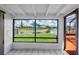 An expansive view of the waterfront from the interior of the home that leads to a back patio at 5144 Cedarbrook Ln, Hernando Beach, FL 34607