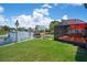 Backyard offers waterfront access, a screened-in patio, lush landscaping, and a birdhouse at 5144 Cedarbrook Ln, Hernando Beach, FL 34607