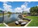 Backyard offers a spot to relax with chairs and a table built in the water and dock access at 5144 Cedarbrook Ln, Hernando Beach, FL 34607