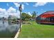 Backyard has access to the water with a personal dock, a birdhouse, and a screened-in patio at 5144 Cedarbrook Ln, Hernando Beach, FL 34607