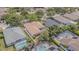 Aerial view showcases a private home with screened pool area and lush landscaping in a desirable neighborhood at 5317 Pagnotta Pl, Lutz, FL 33558