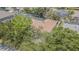 Overhead shot of the home's roof, screened in pool, landscaping and surrounding neighborhood at 5317 Pagnotta Pl, Lutz, FL 33558