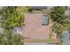 Aerial view of a home with a screened-in pool, mature trees, and well-maintained landscaping at 5317 Pagnotta Pl, Lutz, FL 33558