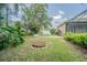 Expansive lawn with mature landscaping, brick path and fire pit found in backyard at 5317 Pagnotta Pl, Lutz, FL 33558