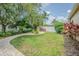 Mature landscaping and a brick walkway adds to the charm of this home's lawn at 5317 Pagnotta Pl, Lutz, FL 33558