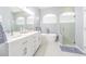 Bright bathroom with a double vanity, soaking tub, and glass-enclosed shower at 5317 Pagnotta Pl, Lutz, FL 33558