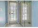 Bathroom interior showcasing glass shower and door leading to outdoor area at 5317 Pagnotta Pl, Lutz, FL 33558