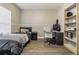 Comfortable bedroom with a twin bed, desk, shelving, and wood-look floors at 5317 Pagnotta Pl, Lutz, FL 33558