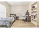 Comfortable bedroom with a twin bed, desk, shelving, and wood-look floors at 5317 Pagnotta Pl, Lutz, FL 33558