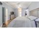 Main bedroom with ensuite bathroom, TV, and decorative dresser at 5317 Pagnotta Pl, Lutz, FL 33558