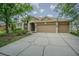 Exterior view showcasing a well-maintained home and its concrete driveway at 5317 Pagnotta Pl, Lutz, FL 33558