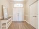 Bright foyer with wood flooring and a decorative mirror at 5317 Pagnotta Pl, Lutz, FL 33558