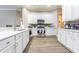 Bright kitchen featuring white cabinets, stainless steel appliances, and modern countertops at 5317 Pagnotta Pl, Lutz, FL 33558