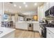 Open kitchen with stainless steel appliances, breakfast bar, and adjacent dining area at 5317 Pagnotta Pl, Lutz, FL 33558